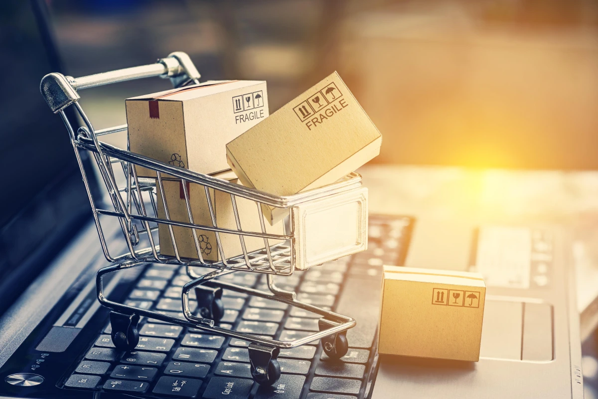 Paper boxes in a shopping cart on a laptop keyboard